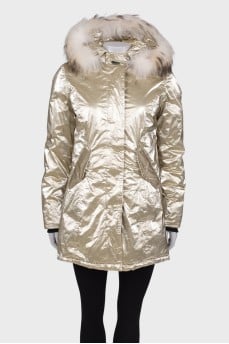 Golden parka with fur on the hood with a tag