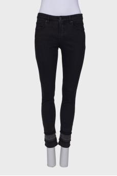 Black jeans embellished at the bottom