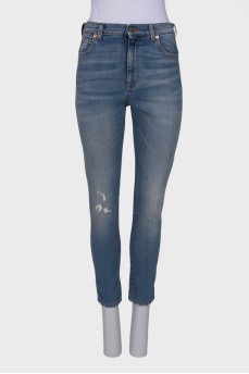 Light blue jeans with distressed patch