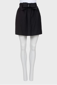 Skirt is decorated with a bow