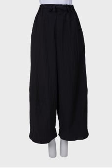 Black trousers with drawstring bottom