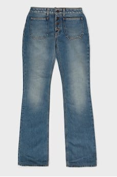 Jeans decorated with pockets with tags