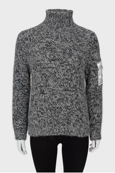 Knitted sweater with pocket on sleeve