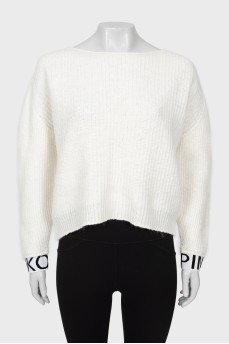 White sweater with logo on cuffs