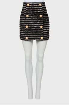 Skirt decorated with golden buttons