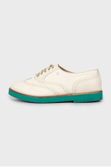 Leather brogues with green sole