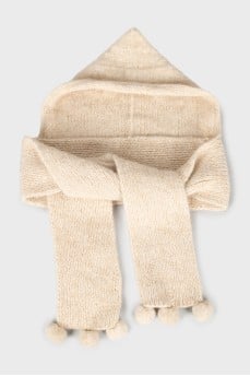 Knitted bonnet with pompoms