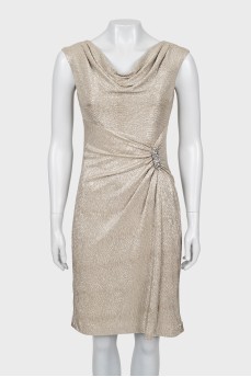 Golden dress decorated with a brooch