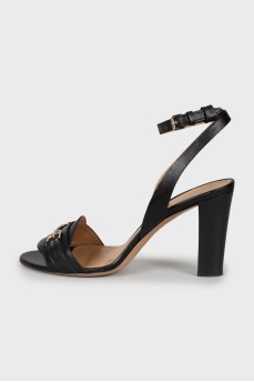 Black leather sandals with metallic decor