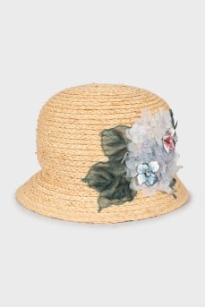Straw hat decorated with flowers with tag