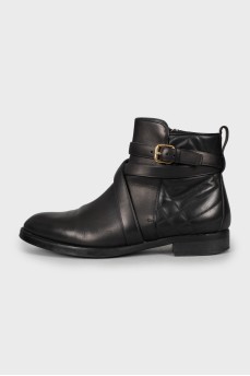 Leather boots decorated with a strap