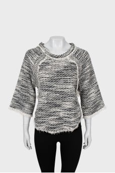 Knitted sweater decorated with fringe