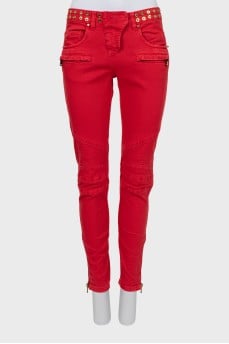 Red jeans decorated with eyelet