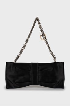 Textile clutch in the form of a bow