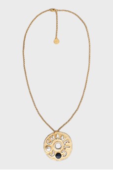 Gold pendant with brand logo