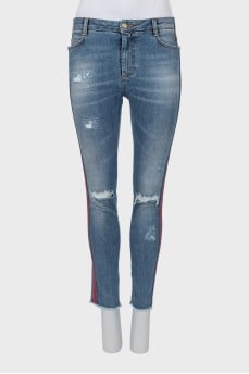 Jeans with stripes and ripped effect