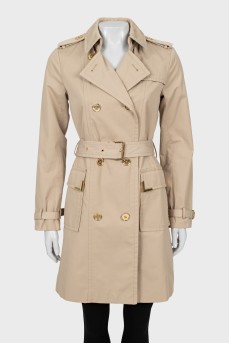 Beige trench coat with gold buttons