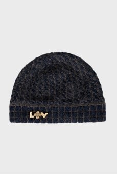 Knitted hat with a golden brooch
