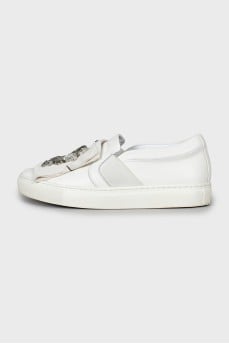 Leather slip-ons decorated with rhinestones