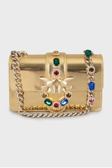 Golden bag decorated with rhinestones