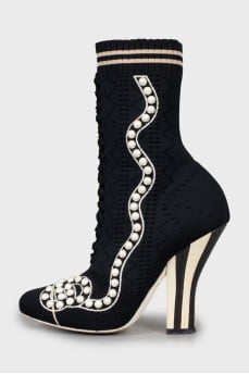 Decorated ankle boots with a figured heel
