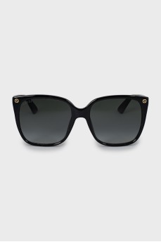 Black sunglasses with gold logo