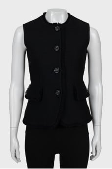 Buttoned waistcoat decorated with fringe and tag