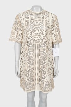 Perforated leather dress with tag