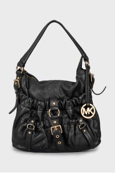 Leather bag decorated with straps