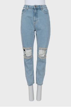 Ripped jeans decorated with crystals