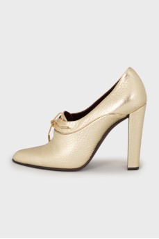 Golden lace-up shoes