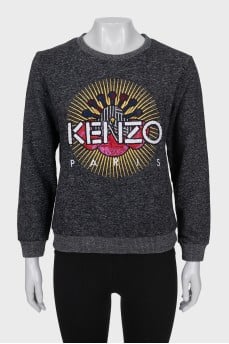Gray sweatshirt decorated with embroidery