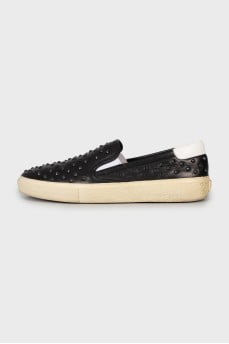 Leather slip-ons decorated with studs