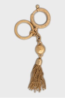 Gold-colored keychain with brand logo