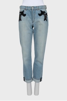 The jeans are decorated with mesh and sequins