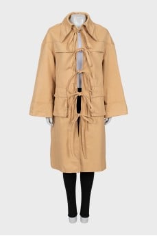 Beige trench coat with ties