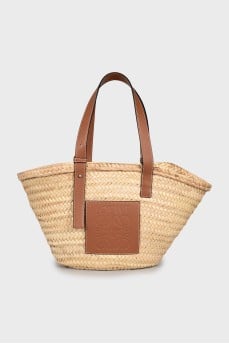 Woven bag with leather handles and logo