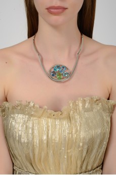 Silver necklace with a round insert of colored stones with a tag