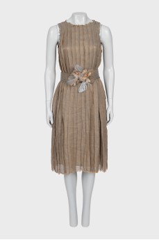 Pleated dress decorated with feathers