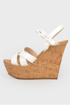 White sandals on high cork wedding