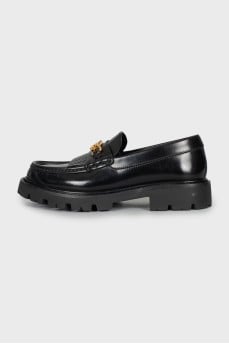 Black leather loafers with signature decor