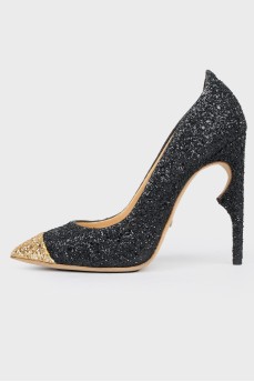 Shiny shoes with a golden toe with a tag