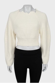 Knitted sweater with a figured collar