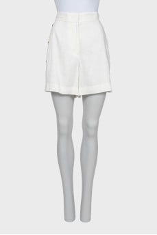 White shorts decorated with golden buttons