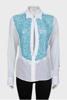 The blouse is decorated with blue stones