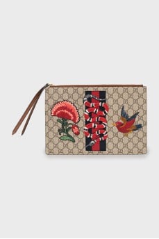 Leather and canvas clutch decorated with patches