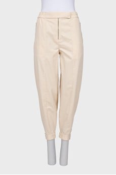 Beige trousers with relief seams