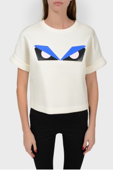 White top with a print of eyes