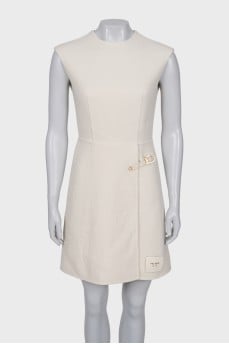 White dress with golden pin