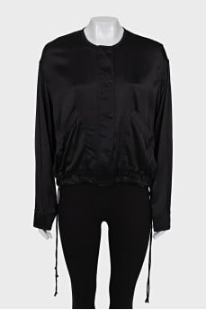 Black bomber jacket with a zipper and buttons